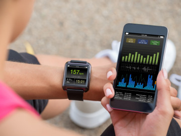 Running Female With Mobile Phone Connected To A Smart Watch